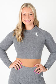 This ribbed crop top has long sleeves and a seamless ribbed texture to provide optimal stretch and comfort.   #color_grey