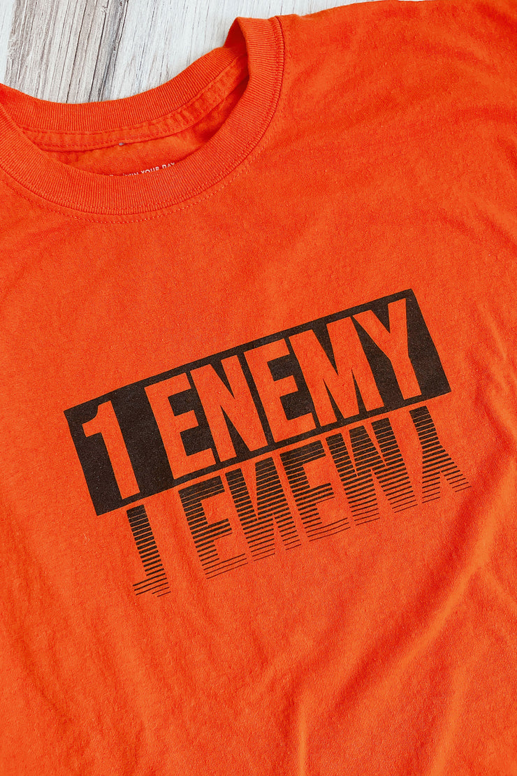 Get your head in the game with this new 1Enemy workout tee in orange and black. A bold new font reflection design to remind us to face the enemy inside.  