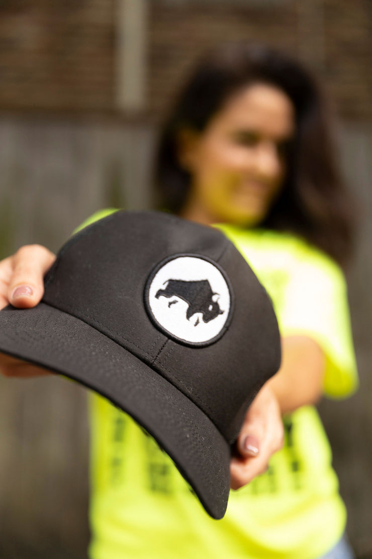 A classic black trucker hat, with our bison emblem on the front to represent our tenacity for strength, and self-determination.